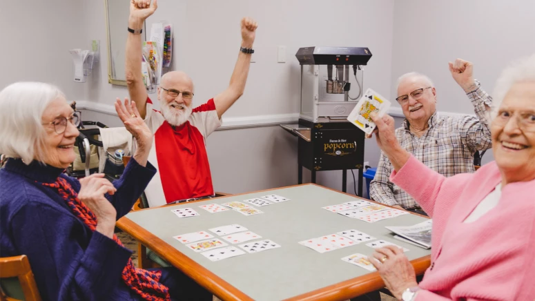 A group of seniors playing a card game