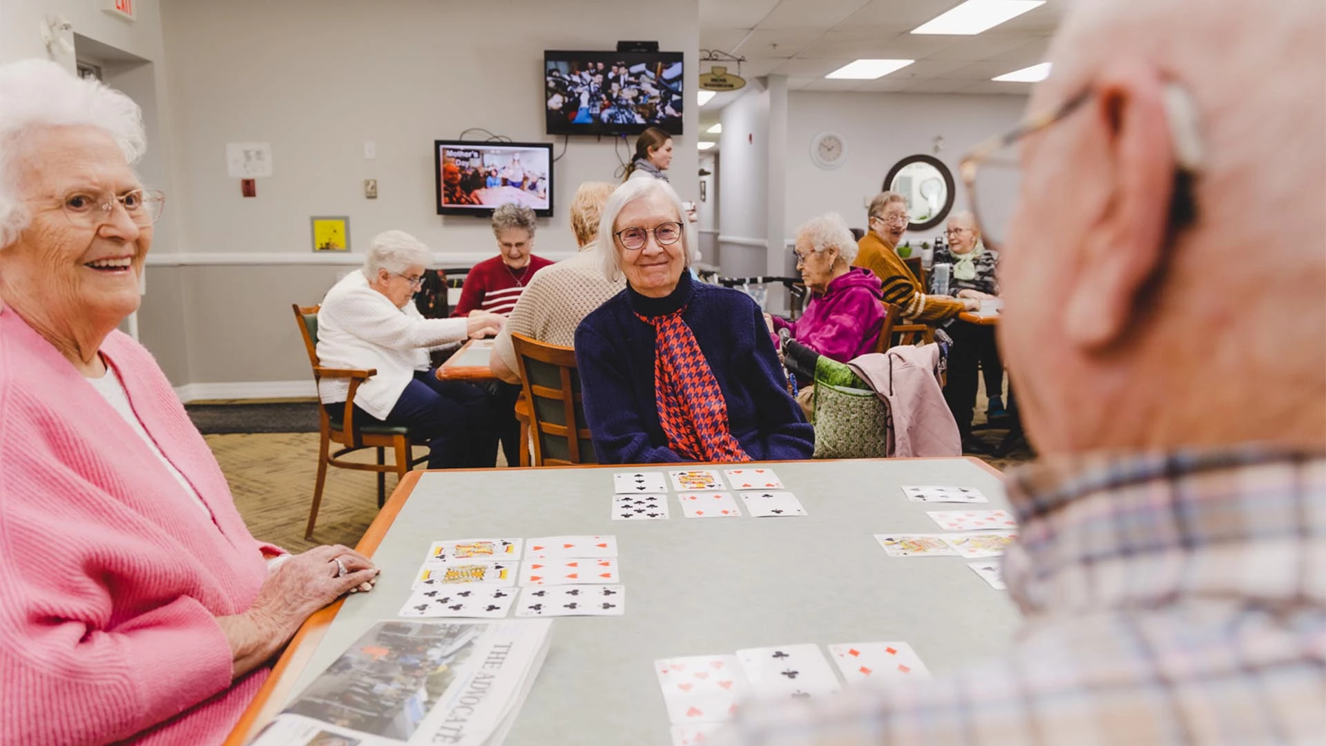 Seniors playing cards together, activities for seniors	at Deer Park Village