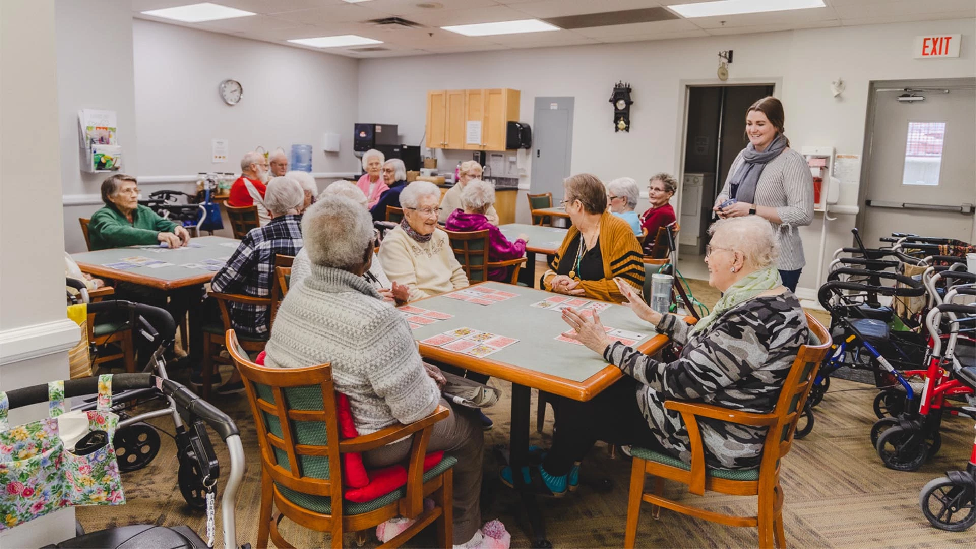 Groups of seniors sitting at card tables playing card games