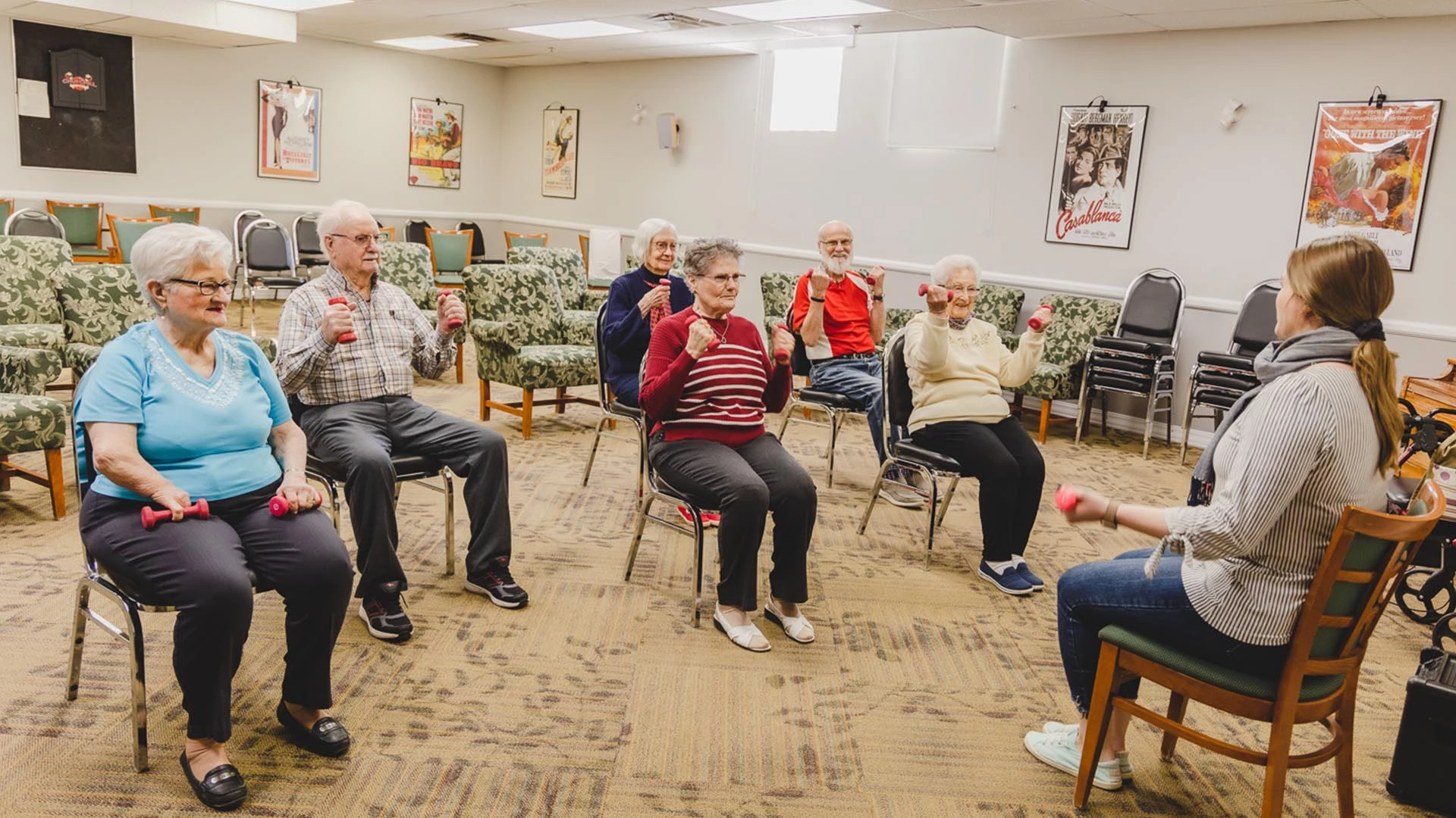 A group of seniors doing chair exercises with light weights